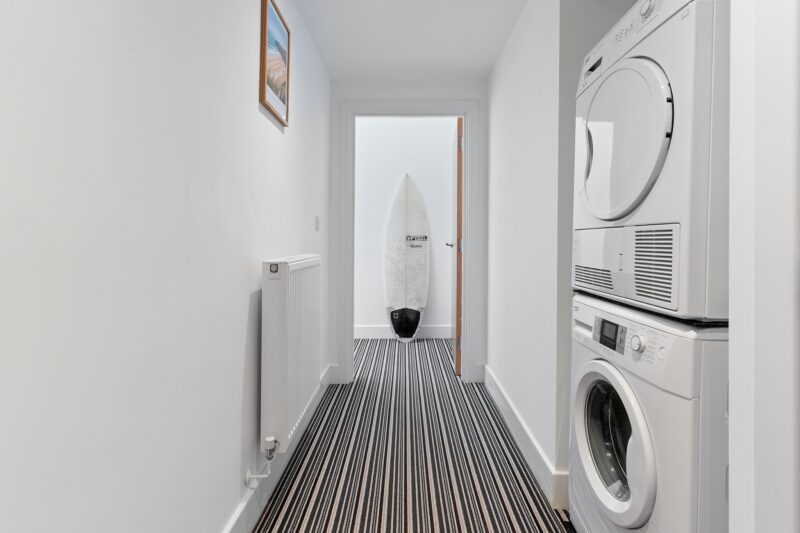 Airbnb Photography in Wadebridge: How Stunning Photos Boost Your Bookings 11 washing marchine and dryer at a wadebridge airbnb